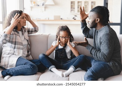 Sad stressed little african preteen girl closing ears feeling scared while her parents divorce, arguing, having marriage problems. Misunderstaning between partners. Psychology therapy. - Powered by Shutterstock