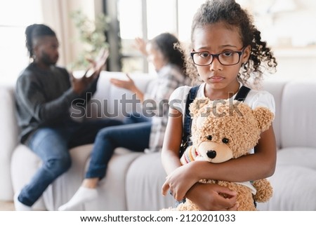 Sad stressed little african preteen girl feeling scared while her parents divorce, arguing, having marriage problems. Misunderstaning between partners. Psychology therapy.