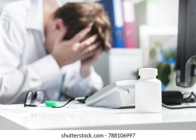 Sad, Stressed, Upset And Unhappy Doctor Cover Face In Hospital Office. Depression, Burnout Stress And Pressure From Too Much Work. Desperate Physician, Medic Or Nurse Made Mistake.