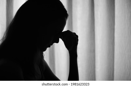 Sad Stressed Woman Silhouette With Hand Over Face Next To Window. 