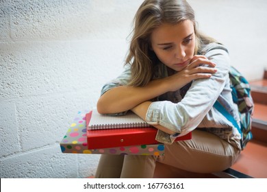 Sad Student Sitting On Stairs In College