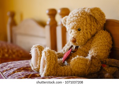 Sad Teddy Bear On A Bed