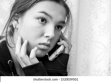 Sad Teen Girl Talking On A Cell Phone