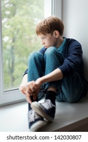 Sad Teen Sitting On Window