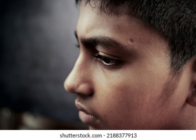 Sad Teenage Boy Looking Away In Dark 