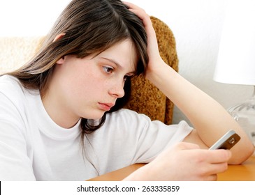 Sad Teenage Girl With Mobile Phone