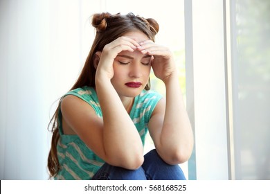 Sad Teenage Girl Sitting Near Window