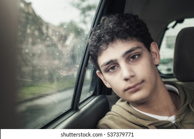 Sad Teenager Boy Inside A Car