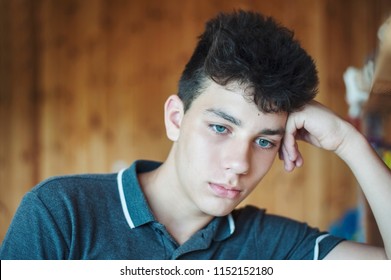 Sad Teenager In The Distance From Home Misses By His Relatives And Regrets Forgetting The Phone At Home And Can Not Call Them. The Boy Has A Very Serious And Sad Look