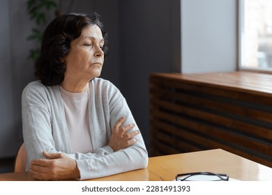 Sad tired ill sick lonely disappointed older senior woman sitting at home alone. Unhappy mature grandmother experiencing grief relative death bad news. Stressed elder lady suffering from loneliness - Powered by Shutterstock