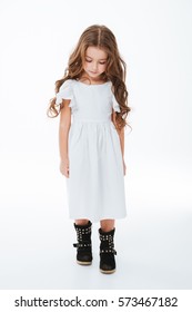 Sad Tired Little Girl With Curly Long Hair Walking And Looking Down Over White Background