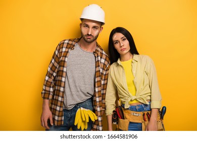 Sad Tired Manual Workers Standing On Yellow  