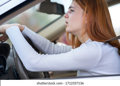 Sad Tired Yound Woman Driver Sitting Behind The Car Steering Wheel In Traffic Jam.