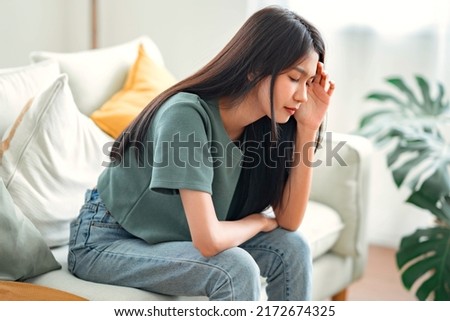 Sad tired young asian woman touching forehead having headache migraine or depression, upset frustrated girl troubled with problem feel stressed, Grief sorrow concept