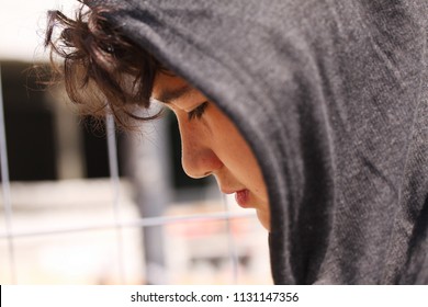 Sad Troubled Hispanic 13 Years Old School Boy Teenager Wearing A Hoodie Posing Outdoor - Close Up Stock Photo