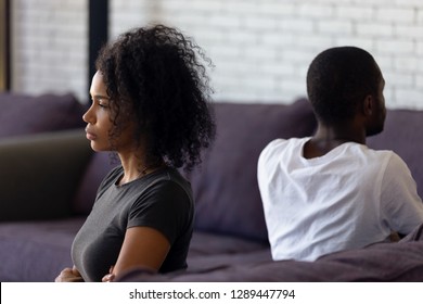 Sad unhappy african wife avoiding talk ignoring husband after couple fight feels indifferent offended, upset frustrated black girlfriend tired of problems, thinking of divorce with selfish boyfriend