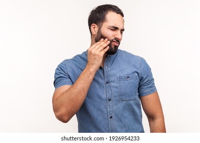 Sad Unhappy Man Touching Cheek Feeling Tooth Pain And Gums Inflammation, Oral Cavity Problems, Need Dentist Consultation. Indoor Studio Shot Isolated On White Background