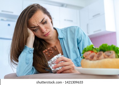 Sad, Unhappy Stressed Crying Woman Eating Chocolate And Sweets Because Of Depression And Emotional Stress. Nerve Food. Life Problems And Difficulties. Food Addiction 