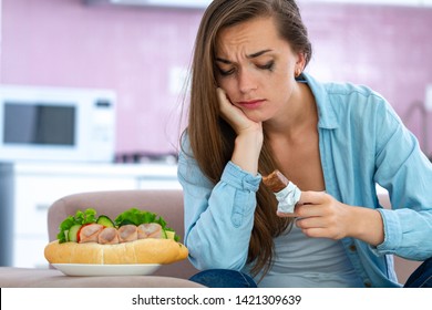 Sad, Unhappy Stressed Crying Woman Eating Unhealthy Junk Food And Chocolate Because Of Depression And Emotional Stress. Nerve Food. Life Problems And Difficulties. Food Addiction 