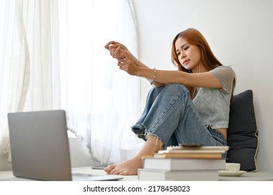 Sad And Unhappy Young Asian Woman Listening A Sad Song With Her Earphones In The Living Room, Having A Love Relationship Problems, Feeling Upset With Herself.