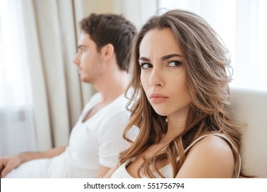 Sad Unhappy Young Couple Having Problems In Bed