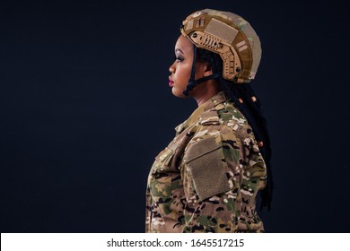 Sad Upset Afro American Army Latin Soldier In Camouflage Clothes Hair Dreadlocks Evening Makeup And Big Lips On A Black Background In The Studio.