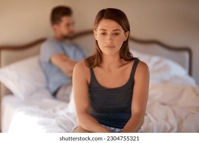 Sad, upset and couple in an argument in their bedroom for divorce or breakup in a modern house. Toxic, mad and face of a woman fighting and in conflict with her boyfriend in bed in their home. - Shutterstock ID 2304755321