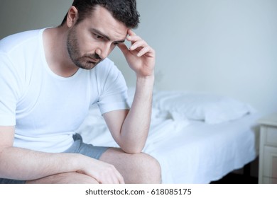 Sad and upset man waking up in the morning light