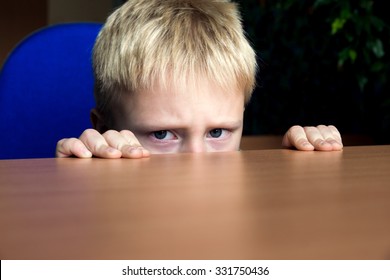 Sad Upset Unhappy Boy Kid Hiding Under The Table