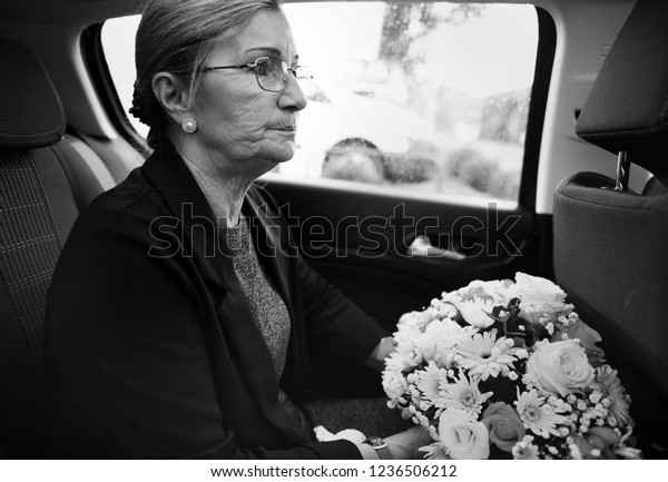 Sad widow on the way to th\
funeral