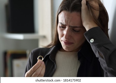 Sad Wife Complaining Looking At Wedding Ring In The Night At Home