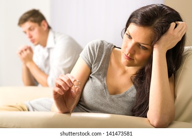 Sad Wife Looking At Her Ring After Fight With Husband