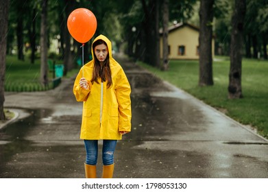 Sad Woman With Balloon Walking In Park, Rainy Day