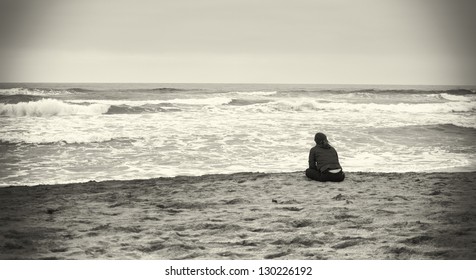 Sad Woman At The Beach In Sepia Colors.