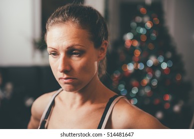 Sad Woman By The Christmas Tree Contemplating