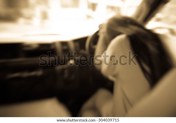 Sad woman in\
car,blurry emotion sepia\
tone