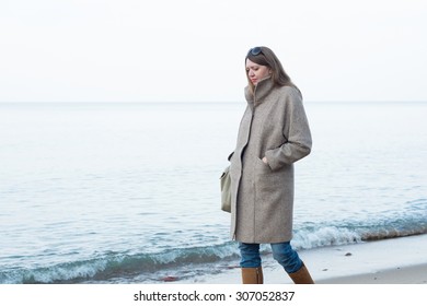 The Sad Woman In A Coat Walks Near The Sea