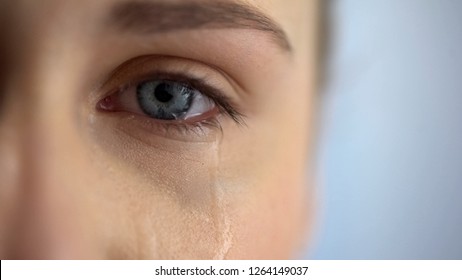 Sad woman crying, suffering pain eyes full of tears, domestic violence victim