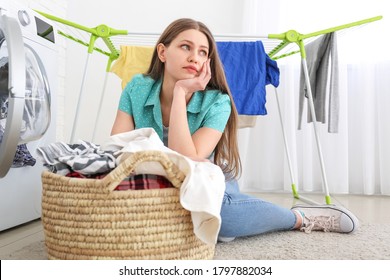 Sad Woman Doing Laundry In Bathroom