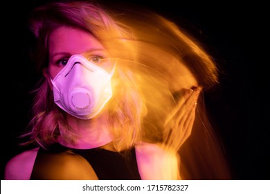 Sad Woman In Face Respirator Mask. Black Background. Environmental Disaster Polluted Air. Virus Protection Covid Corona Long Exposure Creative Artistic Orange And Pink Warm Colors Double Portrait