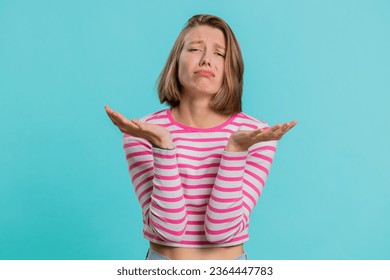 Sad woman feeling hopelessness loneliness, nervous breakdown, loses becoming surprised by lottery results, bad fortune, loss unlucky news. Young girl in crop top isolated on studio blue background - Powered by Shutterstock