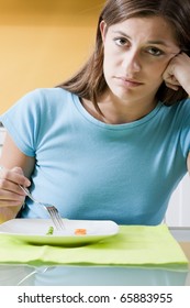 Sad Woman In Front Of Her Small Diet Meal