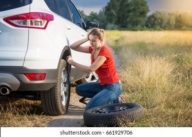 Sad Woman Got Confused About Changing Flat Tire In The Field