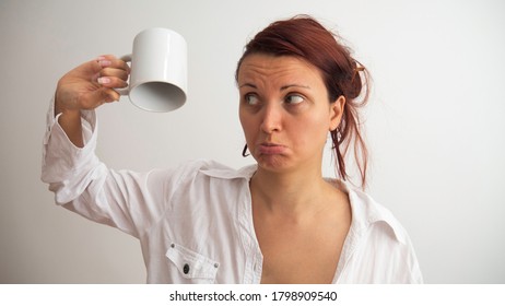 Sad Woman Holding Empty Cup Upside Down. When There Is No Morning Coffee.