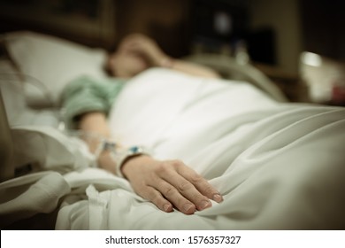 Sad Woman In Hospital Bed.