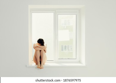 Sad Woman Hug Her Knee And Cry On Window