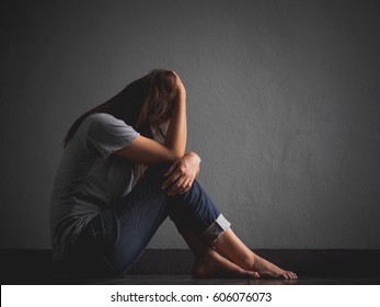 Sad Woman Hug Her Knee And Cry. Sad Woman Sitting Alone In A Empty Room.