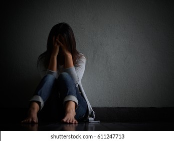 Sad Woman Hug Her Knee And Cry. Sad Woman Sitting Alone In A Empty Room.