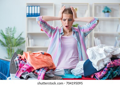 Sad Woman Ironing Clothing At Home