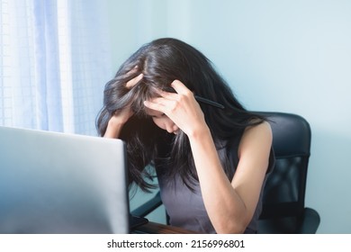 Sad Woman With Laptop Computer. She Very Stressful While Working In Office. Authentic Black Hair And Skin Tan Asian Thailand, Slim Fit. Financial Problems, Broken Heart Concept.Technology Business